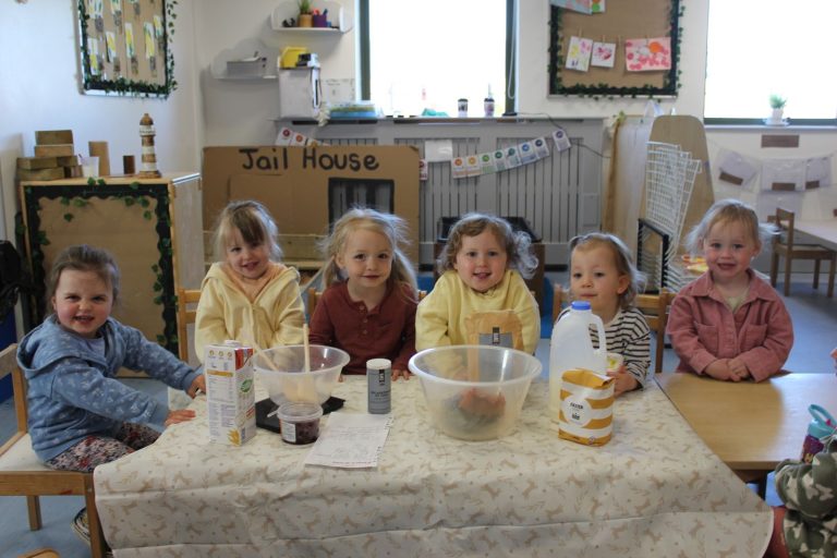 Children gathered round the table for a baking session