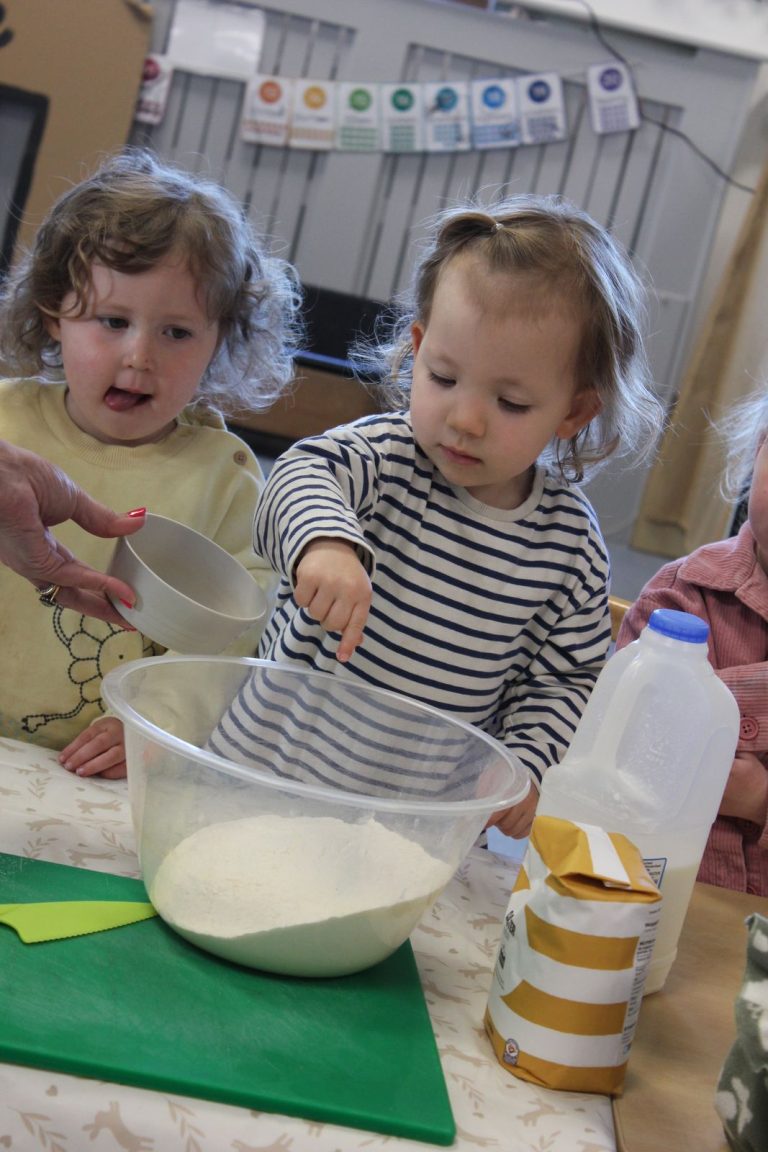 Children mixing flour in a bowl