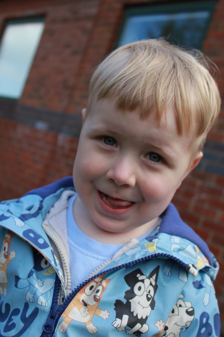 A smiling child in the nursery garden